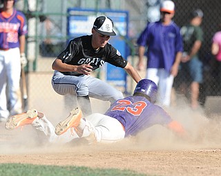 Creekside base runner #23 Santana Barrea slides into home plate to score a run on a passed ball, while Grays pitcher #11 Justin Galan misses the tag in the bottom of the 2nd inning. 