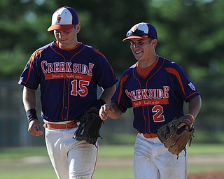 Creekside infielder #2 Steve Sada and teammate #15 Zac Miller both smile while walking of the field after a acrobatic double play by Sada. 