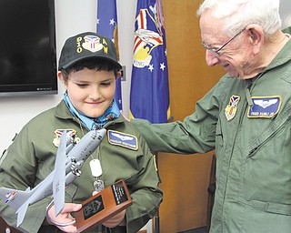 It was smiles all around as Nicholas Greathouse, 10, of Girard received a model of a C-130 cargo plane from Fred Kubli Jr. after the youth was sworn in as an honorary Air Force second lieutenant in the 910th Airlift Wing during Pilot for a Day activities Wednesday at the Youngstown Air Reserve Station in Vienna.