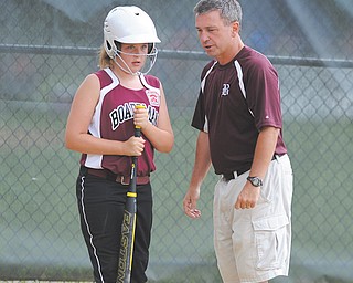 Jenna Burns of the Boardman 10-11 team gets some pointers from coach Brian Gorby before going up to bat during a Little League softball game last weekend at Springfi eld High School. Boardman will be making its second consecutive appearance at the state tournament Monday in Bucyrus.