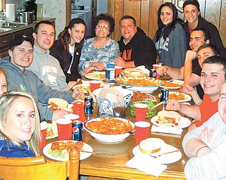 Special to The Vindicator: Surrounding Carol DiFabio (top center) at one of the Italian feasts she prepares each week for her family are, from left, Briana DeRose, niece; Alisa Rasoth, family friend; Mike DeRose, nephew; Vincent Morocco, grandson; Gia DiFabio, granddaughter; Mike DiFabio, her son; Tori Murray and Jami DeFabio, granddaughters; Geno DeFabio, nephew; John Morocco and Mike DeFabio, grandsons; and Billy Stoy, friend.