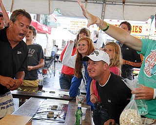 MADELYN P. HASTINGS | THE VINDICATOR
(L-R) Jeff Bartholomew of Youngstown, Jace Kosiorek, 16, Rome Kosiorek, 12, their uncle Chris Kosiorek and Crew Kosiorek, 17, react to a chuck-a-luck game at the 15th annual Our Lady of Mount Carmel Italian Festival on Saturday, July 27. The Kosiorek kids traveled from Spartanburg South Carolina and watch their uncle of Chagrin Falls play the game.