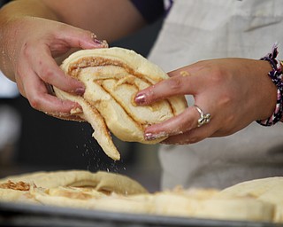 MADELYN P. HASTINGS | THE VINDICATOR
Krista Ulbricht of Youngstown makes cinnamon rolls for the Rimedio's Bakery stand at the 15th annual Our Lady of Mount Carmel Italian Festival on Saturday, July 27.