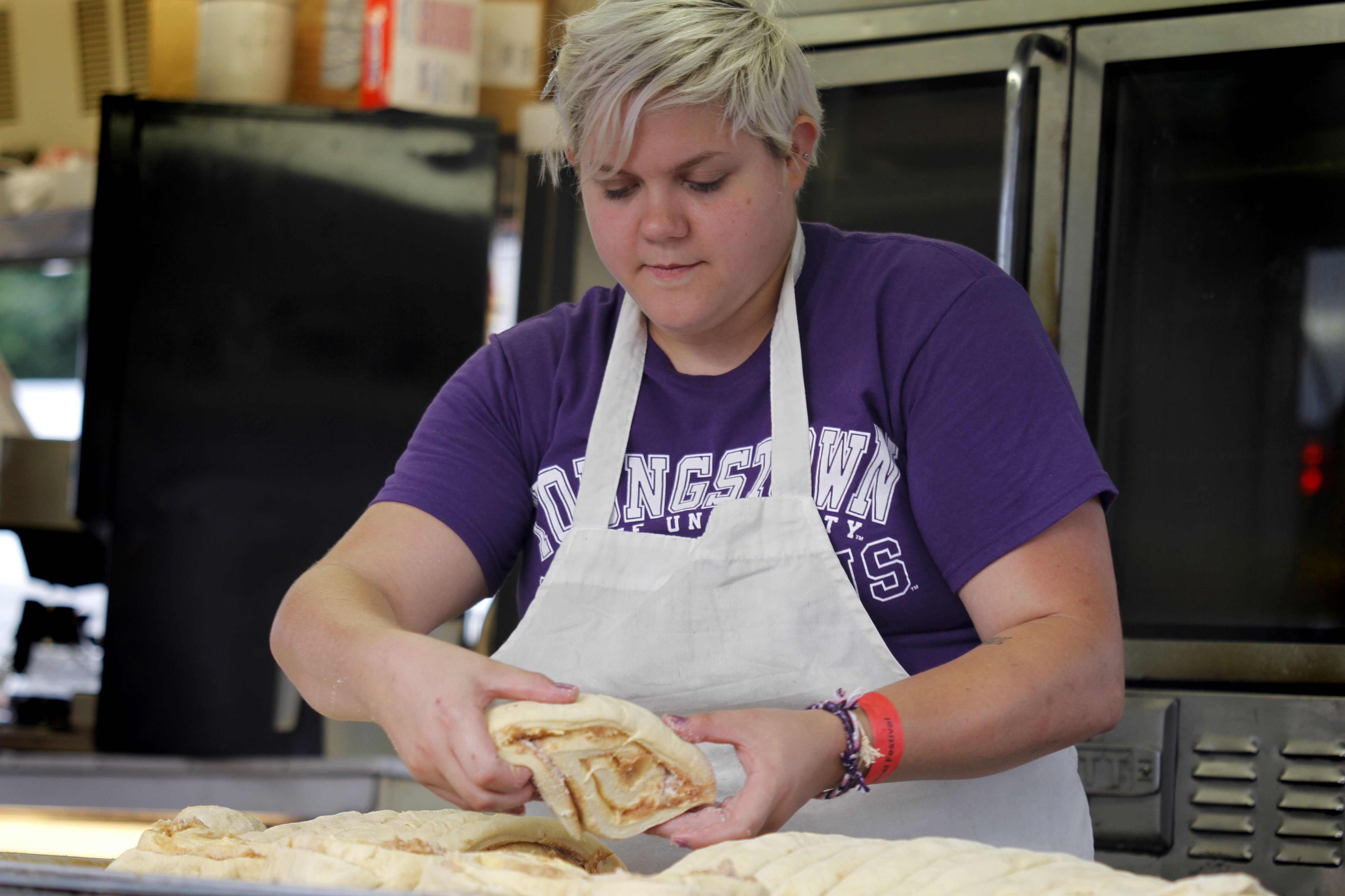 MADELYN P. HASTINGS | THE VINDICATOR

Krista Ulbricht of Youngstown makes cinnamon rolls for the Rimedio's Bakery stand at the 15th annual Our Lady of Mount Carmel Italian Festival on Saturday, July 27.