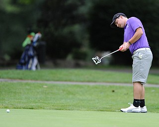Vince Hynes follows through on his putt on a hole on the back 9 Sunday afternoon at Trumbull Country Club.