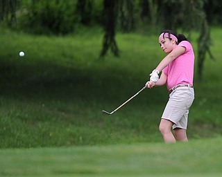 Maura Faviano chips her ball out of the short rough and toward the green on a hole on the back 9 Sunday afternoon at Trumbull Country Club.