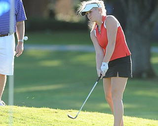 Rachel Williamson chips her ball onto the green on the 18th hole Sunday afternoon at Trumbull Country Club.