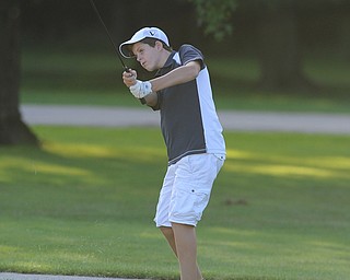 Joey Vitali chips his ball toward the green on the 18th hole Sunday afternoon at Trumbull Country Club.