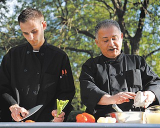 Devlin, left, and Ross Scianna of Antone’s Italian Grille perform a cooking demonstration during the second annual Farm to Fork event Sunday at White House Fruit Farm in Canfield.