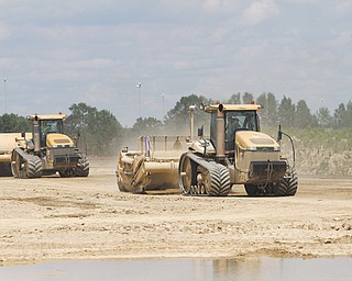 Two excavators work the racetrack, moving dirt from one side of the complex to the other, as Hollywood Slots at Mahoning Valley Race Course begins to take shape. Concrete footers should be started by the end of the week.