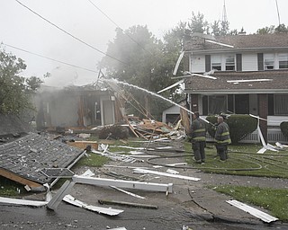        ROBERT K. YOSAY  | THE VINDICATOR

firefighters extinguish the house that exploded..

The house at 535 Cohasset Drive was vacant but the house next door at 539 Cohasset is damaged. In addition, at least four homes across the street from the blast had windows that were broken by the force of the explosion. 