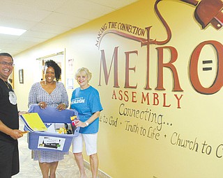 Supporters of the Goodness Invasion, planned Aug. 10 at the Covelli Centre in Youngstown, show a sampling of some of the school supplies being collected to distribute at the event. From left are Pastor Rafael Cruz of the Jericho Project and Unity Baptist Church in Boardman; Kathy Hammond, president of Finer Things Academy, which is a co-sponsor of a “Let’s Move” block party planned the same day downtown; and Anita Oles, food pantry coordinator of God’s Warehouse at New Life Church in Poland.