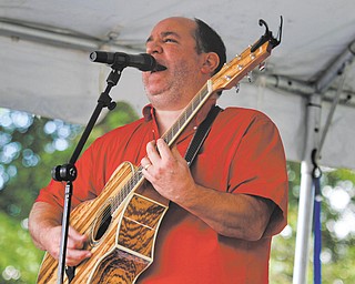 Jay Sylvester sings and plays guitar in the band Lords of Leisure during the Yell for the Well music festival. The festival was held at St. Michael's Catholic Church in Canfield Sunday to raise money toward building a water well in Haiti. The event was created by Nick Crescimanno for his Eagle Scout service project for Troop 115 and featured seven different local bands, fair food, kids games and a bucket auction.
