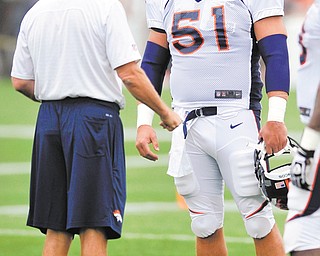Boardman native Steve Vallos talks with Broncos head coach John Fox during training camp in Englewood, Colo. Vallos signed with the team last week and is hoping to extend his NFL career in Denver
