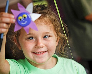 MADELYN P. HASTINGS | THE VINDICATOR..Savannah Cervone, 5, shows off a craft she made at the Austintown National Night Out in the Austintown Township Park on August 6, 2013. This is the first year Austintown participated in the National Night Out hosted by the police department and the trustees. ... - -30-..