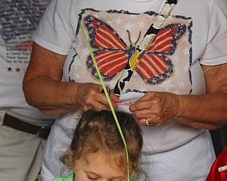 MADELYN P. HASTINGS | THE VINDICATOR..Diane Barnett of Austintown watches her granddaughter Savannah Cervone, 5, make a craft at the Austintown National Night Out in the Austintown Township Park on August 6, 2013. This is the first year Austintown participated in the National Night Out hosted by the police department and the trustees. .... - -30-..