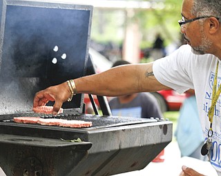 MADELYN P. HASTINGS | THE VINDICATOR..Rick Alli grills burgers at the Youngstown National Night Out at Wick Park on August 6, 2013. This is part of National Night Out program, dedicated to the development and promotion of various crime-prevention programs including neighborhood watch groups, law enforcement agencies, state and regional crime prevention associations, businesses, civic groups, and individuals, devoted to safer communities.... - -30-..