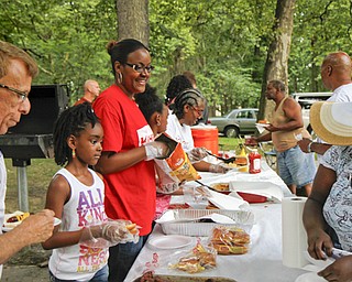 MADELYN P. HASTINGS | THE VINDICATOR..Guests line up to fill their plates at the Youngstown National Night Out at Wick Park on August 6, 2013. This is part of National Night Out program, dedicated to the development and promotion of various crime-prevention programs including neighborhood watch groups, law enforcement agencies, state and regional crime prevention associations, businesses, civic groups, and individuals, devoted to safer communities.... - -30-..
