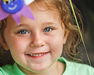 MADELYN P. HASTINGS | THE VINDICATOR..Savannah Cervone, 5, shows off a craft she made at the Austintown National Night Out in the Austintown Township Park on August 6, 2013. This is the first year Austintown participated in the National Night Out hosted by the police department and the trustees. ... - -30-..