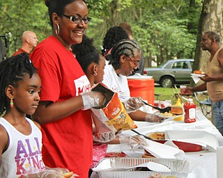 MADELYN P. HASTINGS | THE VINDICATOR..Guests line up to fill their plates at the Youngstown National Night Out at Wick Park on August 6, 2013. This is part of National Night Out program, dedicated to the development and promotion of various crime-prevention programs including neighborhood watch groups, law enforcement agencies, state and regional crime prevention associations, businesses, civic groups, and individuals, devoted to safer communities.... - -30-..