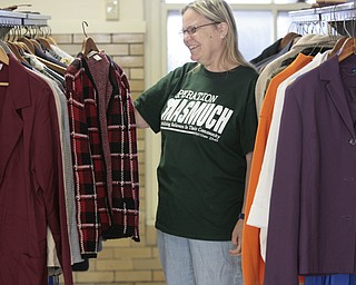 ROBERT K. YOSAY | THE VINDICATOR
Beth Monroe checks out a jacket as she sorts out clothes in the basement of First Christian Church
In As Much Day of service
First Christian Church, Broadway Ave., Girard: Pastor Ron Maurer
Pastor Ron does car checks at event, which will be Aug. 10;