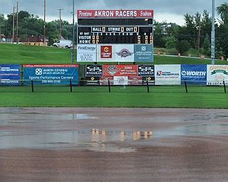 Water pools on the field during a downpour at Firestone Stadium in Akron. 