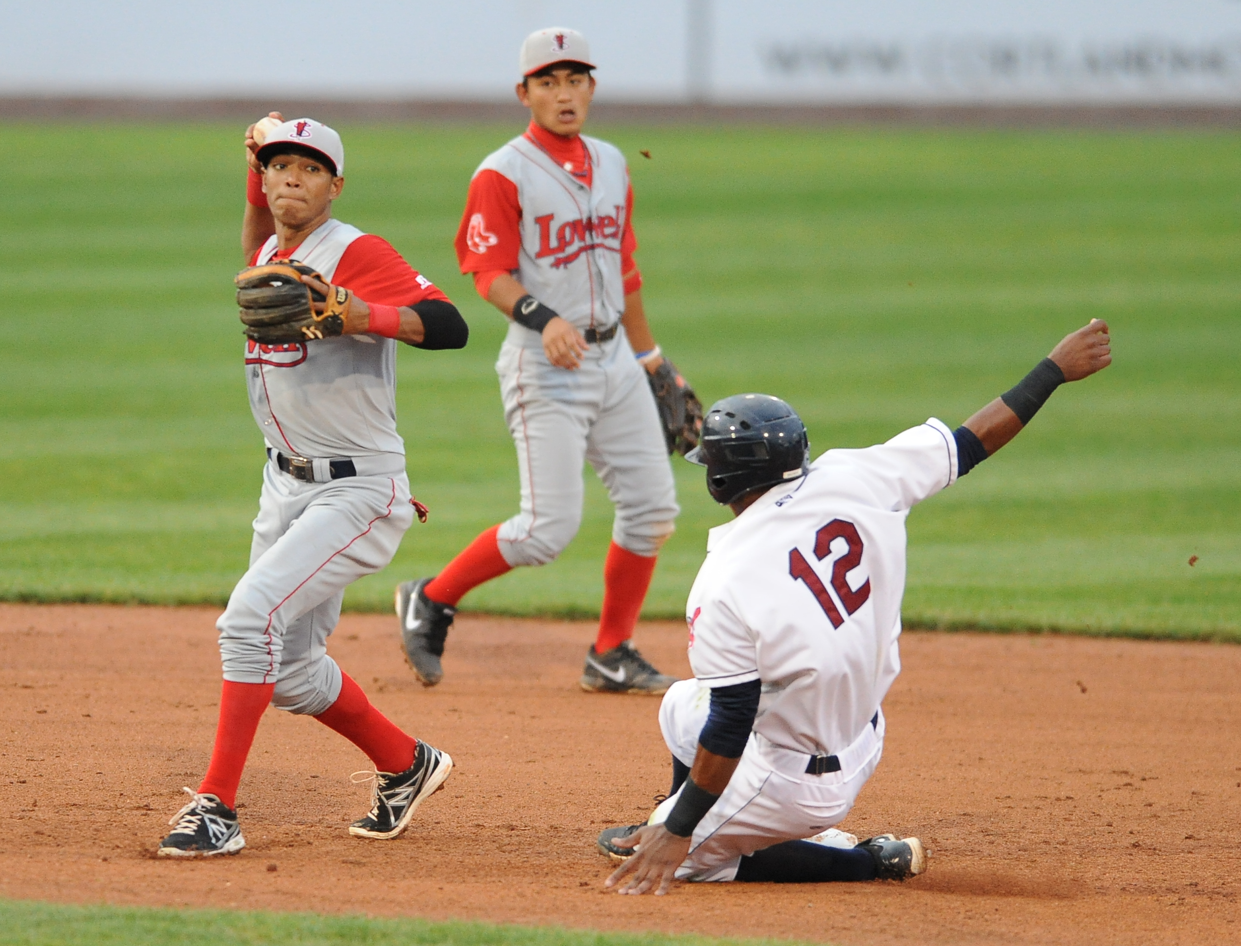 Lowell second basemen #5 Deiner Lopez prepares to throw the ball to first base after stepping on second base to force out Scrappers base runner #12 Claudio Bautista to turn the double play to end the 4th inning.