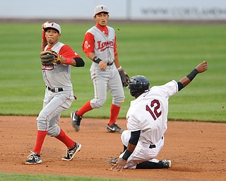 Lowell second basemen #5 Deiner Lopez prepares to throw the ball to first base after stepping on second base to force out Scrappers base runner #12 Claudio Bautista to turn the double play to end the 4th inning.