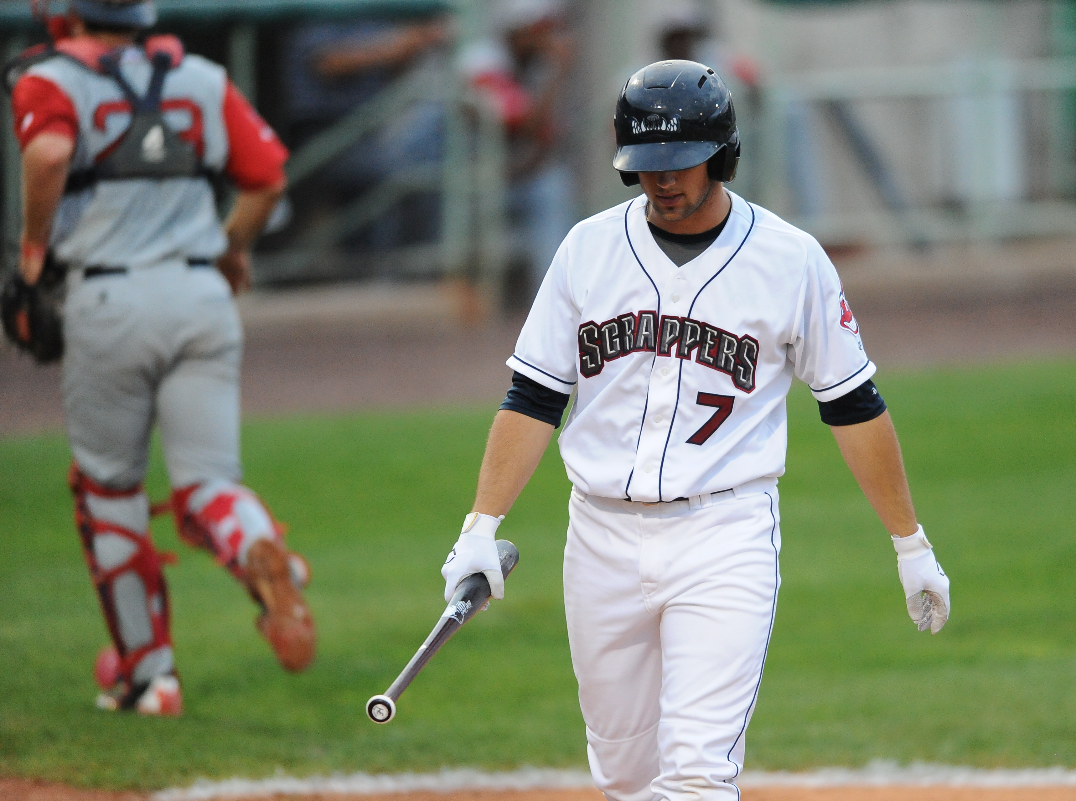 Scrappers batter #7 Josh McAdams  walks back to the dugout after striking out to end 4th inning. Lowell catcher #23 Danny Bathea