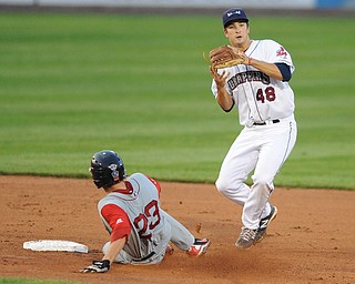 Scrappers infielder #48 James Roberts jumps in the air after stepping on second base after stepping on second base to force out Lowell base runner #23 Danny Bathea. The throw to first base would not be in time to first. 
