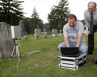 MADELYN P. HASTINGS | THE VINDICATOR
(L-R) Matt O'Mansky and Jerry Ward look at the results of a 3-D scan of the eroded tombstone of George Foulkes. O’Mansky is using the scanner to try to make out the words on the tombstone in the Glenview Cemetery in East Palestine. O'Mansky was contacted by Ward, who is a descendant of Foulkes. Foulkes was captured by Indians as a young boy in 1780 and remained a captive for 11 years before escaping.