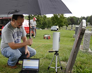 MADELYN P. HASTINGS | THE VINDICATOR
Matt O’Mansky is using a 3-D scanner to try to make out the words on a very old eroded tombstone in the Glenview Cemetery in East Palestine. O'Mansky was contacted by a descendant of George Foulkes, who the tombstone is dedicated to. Foulkes was captured by Indians as a young boy in 1780 and remained a captive for 11 years before escaping.
