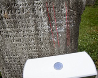 MADELYN P. HASTINGS | THE VINDICATOR
Matt O’Mansky is using a 3-D scanner to try to make out the words on a very old eroded tombstone in the Glenview Cemetery in East Palestine. O'Mansky was contacted by a descendant of George Foulkes, who the tombstone is dedicated to. Foulkes was captured by Indians as a young boy in 1780 and remained a captive for 11 years before escaping.