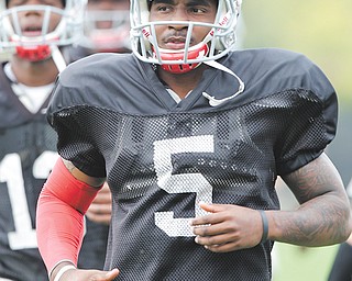 Braxton Miller warms up during practice on Wednesday. OSU officials said the quarterback has been cleared of any NCAA violations.
