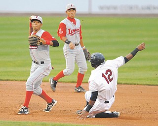 Lowell second basemen Deiner Lopez, left, throws to first base after forcing out Scrappers base runner Claudio Bautista (12) to start a fourth-inning double play Wednesday night.