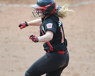 Canfield base runner #16 Amelia Manenti  jumps in the air after scoring the game winning run in the bottom of the 8th inning. 