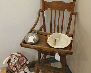 ROBERT K. YOSAY | THE VINDICATOR..an antique high chair and bowl..Larry and Ann Canale have been running an antiques business for more than five years. Their operation started from a small house in Columbiana, but has since expanded to a storefront there with 6,000 square feet. A feature on their business and how theyÕve managed to grow.--AnnÕs Attic Antiques & Furniture, Columbiana.... - -30-..