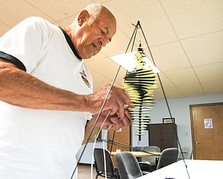 Edward Gabrick builds a Whirly Jig at the Senior Independence Adult Day Care Center in Boardman, the new home for people who used to be clients of the Mahoning County Adult Day Care program operated by the district board of health.