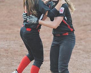 Canfield’s Ellie Dundics, left, hugs teammate Maddy Johns (2) after Johns batted in the game-winning run
Thursday in the bottom of the eighth inning of the 13-14 Junior League Central Region championship against
South Portage (Mich.) at Akron’s Firestone Stadium. Canfield won 2-1 and earned a berth in the Junior League
World Series this weekend in Kirkland, Wash. Inclement weather on Wednesday had forced the teams to continue
play Thursday.