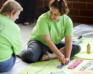 MADELYN P. HASTINGS | THE VINDICATOR..(L-R) Jenifer Edwards and Suzy Mickler design their banner on behalf of Children's Services during the Community Cup banner competition at the Central YMCA in downtown Youngstown on Friday, August 9, 2013.... - -30-..