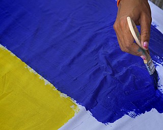 MADELYN P. HASTINGS | THE VINDICATOR..Rachel Emerson of Leetonia paints a banner during the Community Cup banner competition at the Central YMCA in downtown Youngstown on Friday, August 9, 2013.... - -30-..