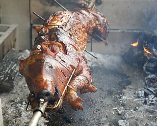 MADELYN P. HASTINGS | THE VINDICATOR..A pig is slow roasted from 10-7 at the 2nd Annual International Latino Food Fest at the OCCHA Social Hall in Youngstown on Friday, August 9, 2013. .. - -30-..