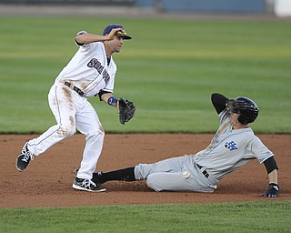 Scrappers second basemen #9 Paul Hendrix prepares to jump over a sliding Renegades base runner #23 Graden Goetzman after the throw from the catcher was off the mark and low. The ball would end up in shallow left field on August 9, 2013.