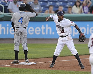 Scrappers third basemen #12 Claudio Bautista prepares to throw the ball around after tagging out Hudson Valley base runner #4 Ariel Soriano who was attempting to steal third base in the top of the 5th inning on August 9, 2013.