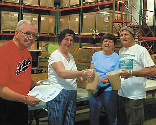 SPECIAL TO THE VINDICATOR
Trumbull Retired Teachers, from left, Joe and Betty Jean Behmer and Eva and Vic Bell, recently volunteered at Second Harvest Food Bank as part of a Day of Service. TRTA will meet at noon Tuesday for a luncheon at Ciminero’s Banquet Center, 123 N. Main St., Niles. To make a reservation send $11.25 to Ellen King, 7141 Vineland Place, Youngstown, OH 44512-4845. Make checks payable to TRTA. The community services committee is collecting used eyeglasses, hearing aids, cellphones, canceled stamps, candle wax and worsted yarn. For information visit www.trumbullrta.blogspot.com or Facebook.