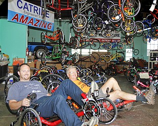 MADELYN P. HASTINGS | THE VINDICATOR...(L-R) Travis and Wayne Wallace pose in their adult tricycle store in Lisbon, Rail to Trail. The store in No. 1 in the world for sales of the Catrike tricycles. .. - -30-..