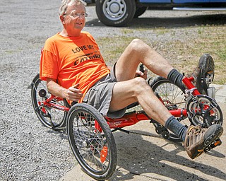 MADELYN P. HASTINGS | THE VINDICATOR..Owner of Rail to Trail adult tricycle store in Lisbon, Wayne Wallace, rides one of his tricycles in the parking lot of his store. The store in No. 1 in the world for sales of the Catrike tricycles. ... - -30-..