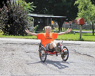 MADELYN P. HASTINGS | THE VINDICATOR..Owner of Rail to Trail adult tricycle store in Lisbon, Wayne Wallace, rides one of his tricycles in the parking lot of his store. The store in No. 1 in the world for sales of the Catrike tricycles. ... - -30-..