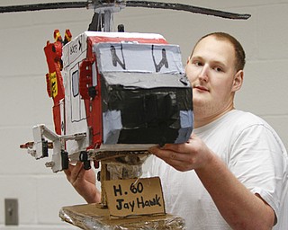 ROBERT K. YOSAY | THE VINDICATOR..Logan with his H-60 Jay Hawk helicopter Logan, a young adult at Gateways to Better Living, is considered by staff members to be a noteworthy artist ....... - -30-..