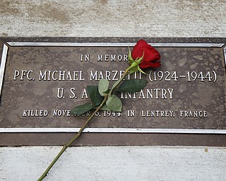 MADELYN P. HASTINGS | THE VINDICATOR..The plaque of PFC. Michael Marzetti, who died on November 5, 1944 in Lentrey, France. A rededication of 17 plaques honoring local veterans who died in combat during World War II and the Vietnam War was part of Lowellville Day on Saturday, August 10, 2013 in downtown Lowellville.... - -30-..